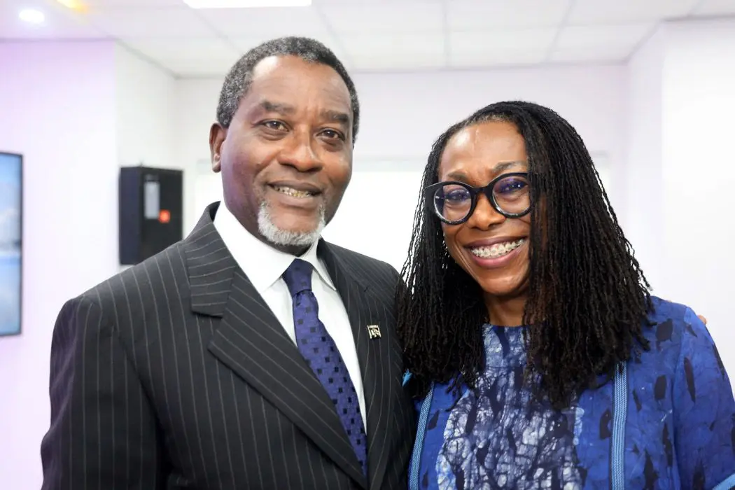 Abimbola Olashore at a formal event with a guest