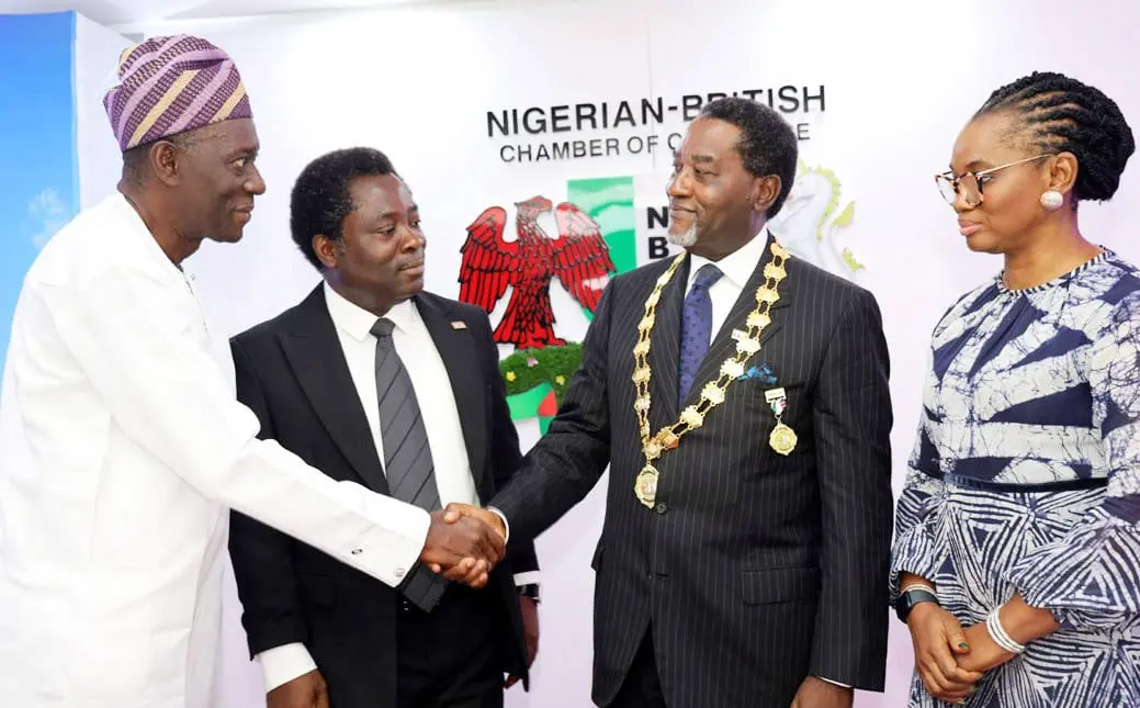 Abimbola Olashore in a ceremonial handshake moment